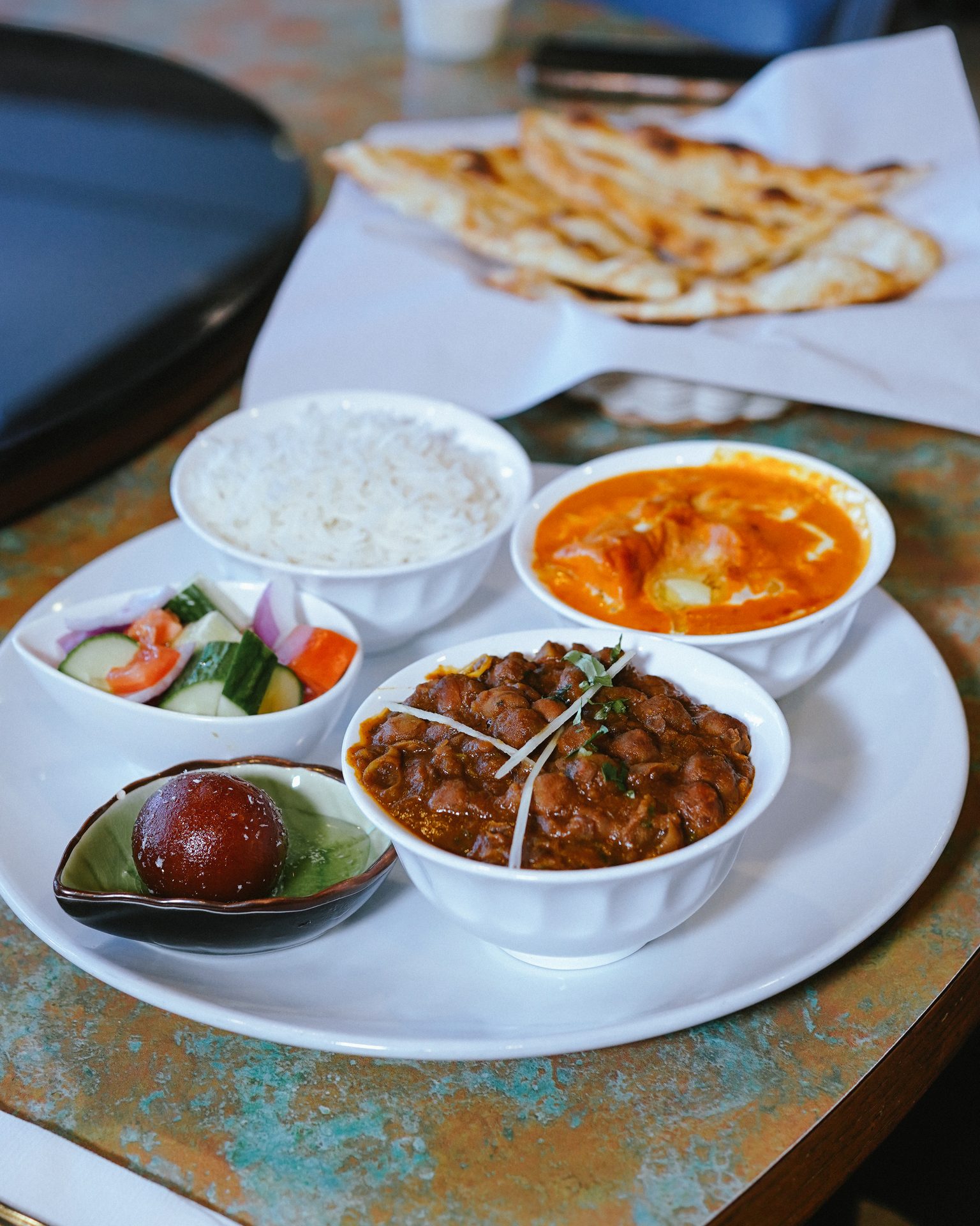 Overhead view of an Indian thali with a selection of dishes at Cardamom The Indian Kitchen